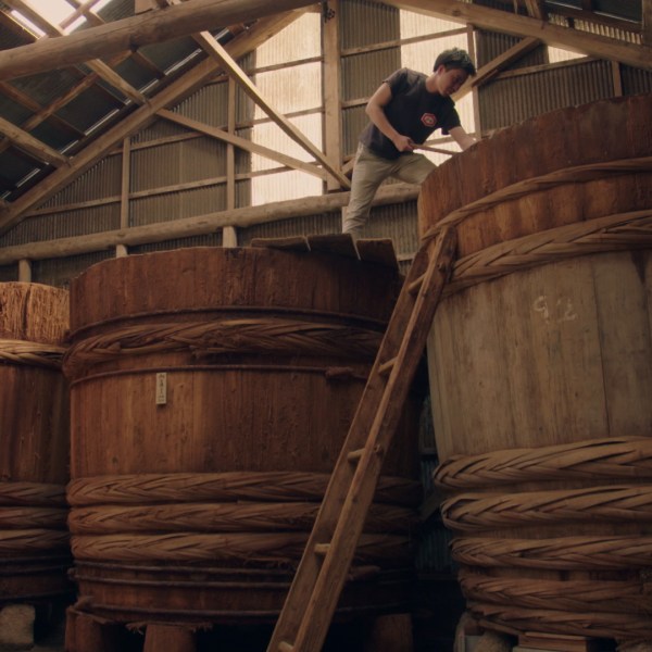 Soy being mixed in a large barrel for Yaemon Tamari at Clearspring.