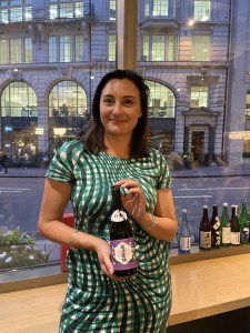 Individual photo of member attending the BSA Study Group at Vagabond Monument and holding bottle of Ginjo sake